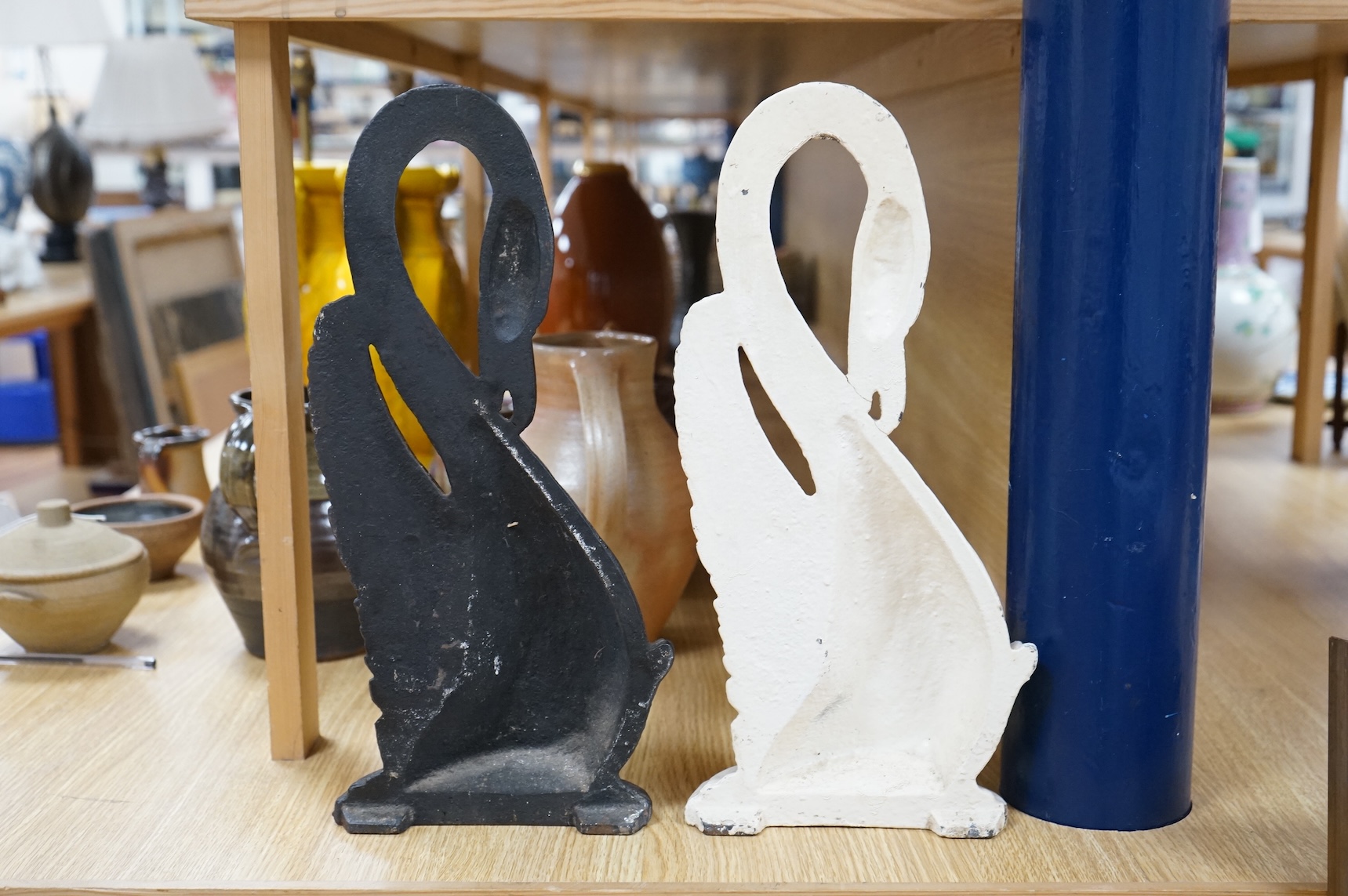 Two Victorian cast iron ‘swan’ door stops, one painted, 38cm